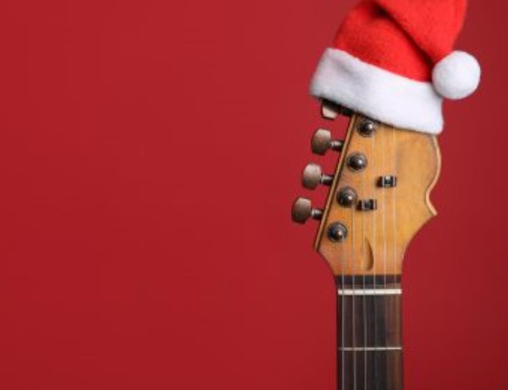 guitar-with-santa-hat-red-background-space-text-christmas-music-concept-350x260