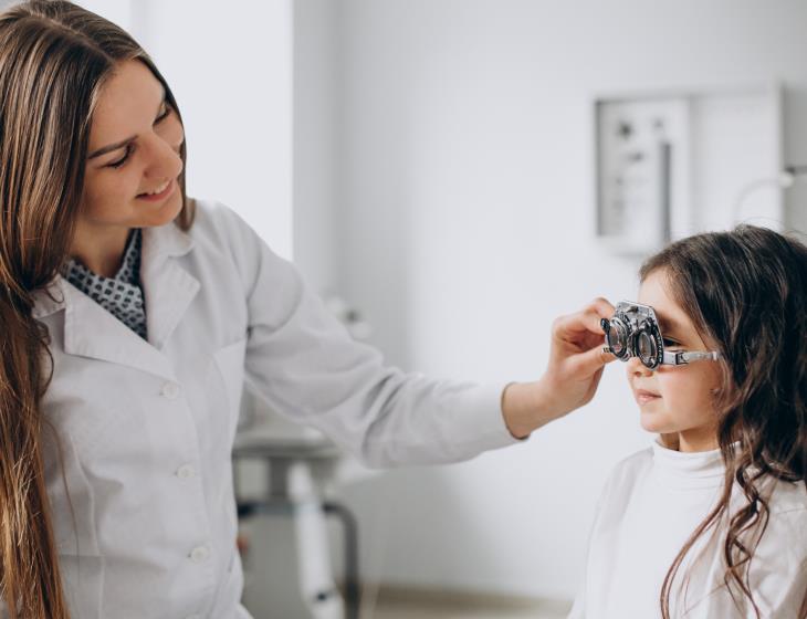 Little girl checking up her sight at ophthalmology center